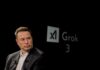 Elon Musk speaking during a technology event with a dark background
