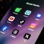 Close-up of a smartphone screen displaying various social media app icons