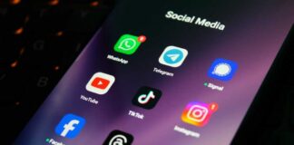 Close-up of a smartphone screen displaying various social media app icons