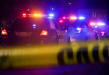 Crowd Panic! Atlantic Beach Bike Fest Turns Dangerous Police cars with flashing lights at a nighttime scene behind crime scene tape