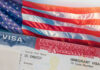 Citizenship Proposal Sparks Elitism Backlash Close-up of a US visa with an American flag in the background