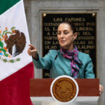 WORLD CUP CHAOS: Mexico’s DARK Secret Exposed! A government official delivering a speech in front of the Mexican flag