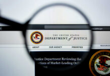 Close-up view of the Department of Justice website through a magnifying glass