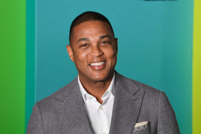 Smiling man in a gray suit with a colorful background