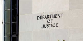 Sign on the exterior wall of the Department of Justice building