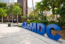 Secret Land Deal for Trump Library Exposed! Large blue sculpture in an urban park with palm trees
