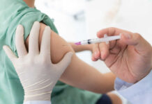 A healthcare professional administering a vaccine to a patient's arm