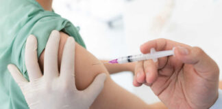 A healthcare professional administering a vaccine to a patient's arm