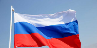 Russian flag waving against a clear blue sky