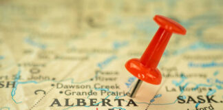 Red pushpin marking Alberta on a map