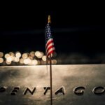 Pentagon’s Billion-Dollar AI Gamble: Truth or Hype? A small American flag positioned in front of the word 'PENTAGON' on a reflective surface
