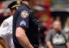 Close-up of a police officers uniform in a busy urban area