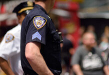 Close-up of a police officers uniform in a busy urban area