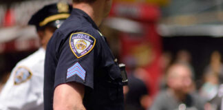 Close-up of a police officers uniform in a busy urban area