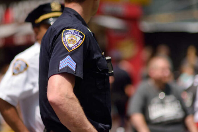 Close-up of a police officers uniform in a busy urban area