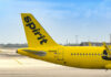 Close-up of the tail of a Spirit Airlines airplane at an airport