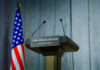 Mysterious Bursts Trigger White House Security Rush Press podium with microphones and American flag in the background