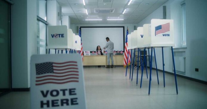 Interior of a polling station with voting booths and officials