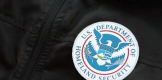 Close-up of a U.S. Department of Homeland Security badge on a black jacket