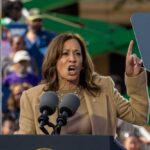 A woman passionately delivering a speech at a rally