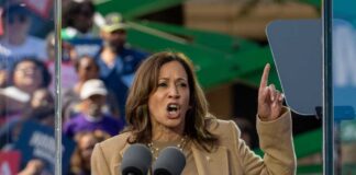 A woman passionately delivering a speech at a rally