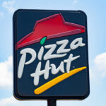 Pizza Delivery NIGHTMARE — AI Blamed for $100M Loss! restaurant sign with red roof logo against blue sky