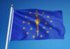 Indiana state flag waving against a blue sky
