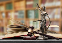 Legal Earthquake: Court Crushes Jury Bias Cover-Up A gavel and a statue of Lady Justice beside an open law book