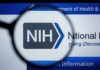 Pentagon Research Freeze Sparks Ethics Brawl Scientist examining samples under a microscope in a laboratory