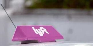 Car roof with a pink rideshare sign