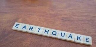 Scrabble tiles spelling earthquake on a wooden table