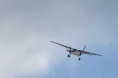 2641736555 Small propeller airplane flying against a cloudy sky