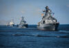 Deal Signed, Tankers Still Frozen A fleet of military ships sailing in the ocean