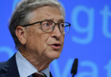 Grave Error Or Cover-Up? Bill Gates Grilled A man in a suit speaking at a conference with a microphone