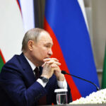Putin’s Referendum Gambit Backfires A government official sitting at a conference table with a serious expression