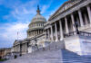 House Revolt Rattles White House The U.S. Capitol building with its iconic dome and steps under a blue sky