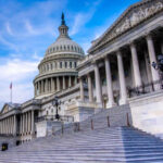 House Revolt Rattles White House The U.S. Capitol building with its iconic dome and steps under a blue sky