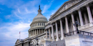 The U.S. Capitol building with its iconic dome and steps under a blue sky