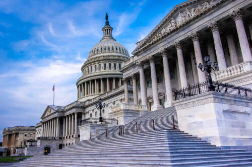 Stairs,Raising,To,The,East,Entrance,Of,The,Domed,Marble The U.S. Capitol building with its iconic dome and steps under a blue sky