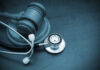 Patient IDs Flipped For Fast Money A wooden gavel next to a stethoscope on a dark surface
