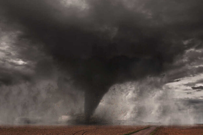 Tornado A tornado forming in a dark, stormy sky over a field