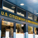 Trump’s Denaturalization Machine Roars Back Entrance of the U.S. Citizenship and Immigration Services office with signage
