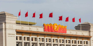 Facade of the National Museum of China adorned with red flags and decorative elements