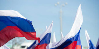 Multiple Russian flags waving in the wind at an outdoor event