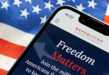 Does Campaign Cash Predict Election Wins? Smartphone displaying a political message over an American flag background