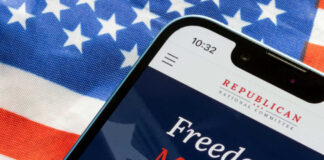 Smartphone displaying a political message over an American flag background