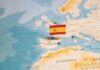 Migrant Applications Far Exceed Expectations Map highlighting Spain with a small flag
