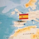Map highlighting Spain with a small flag