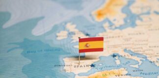 Map highlighting Spain with a small flag