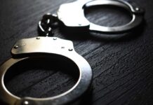 Dryer Rescue Sparks Bigger Mystery Close-up of metallic handcuffs on a textured surface